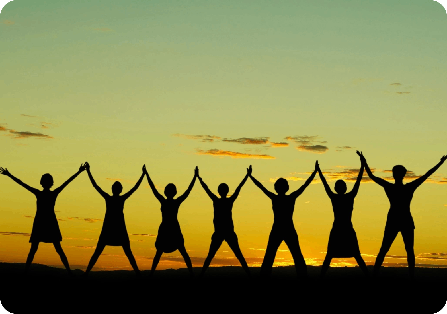 A group of people holding hands in the air.